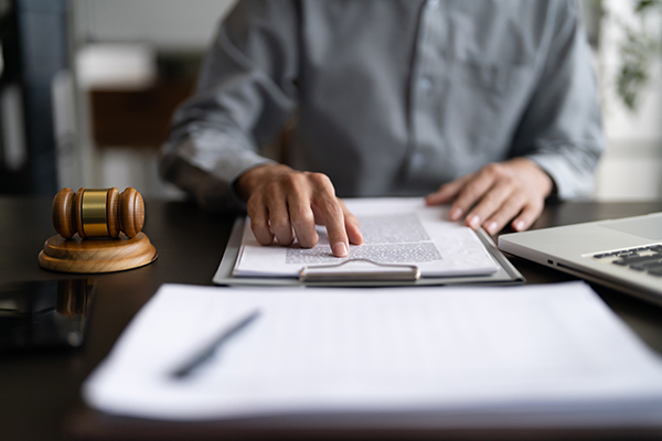Lawyer,Or,Judge,Counselor,Reading,A,Important,Legal,Contract,Documents
